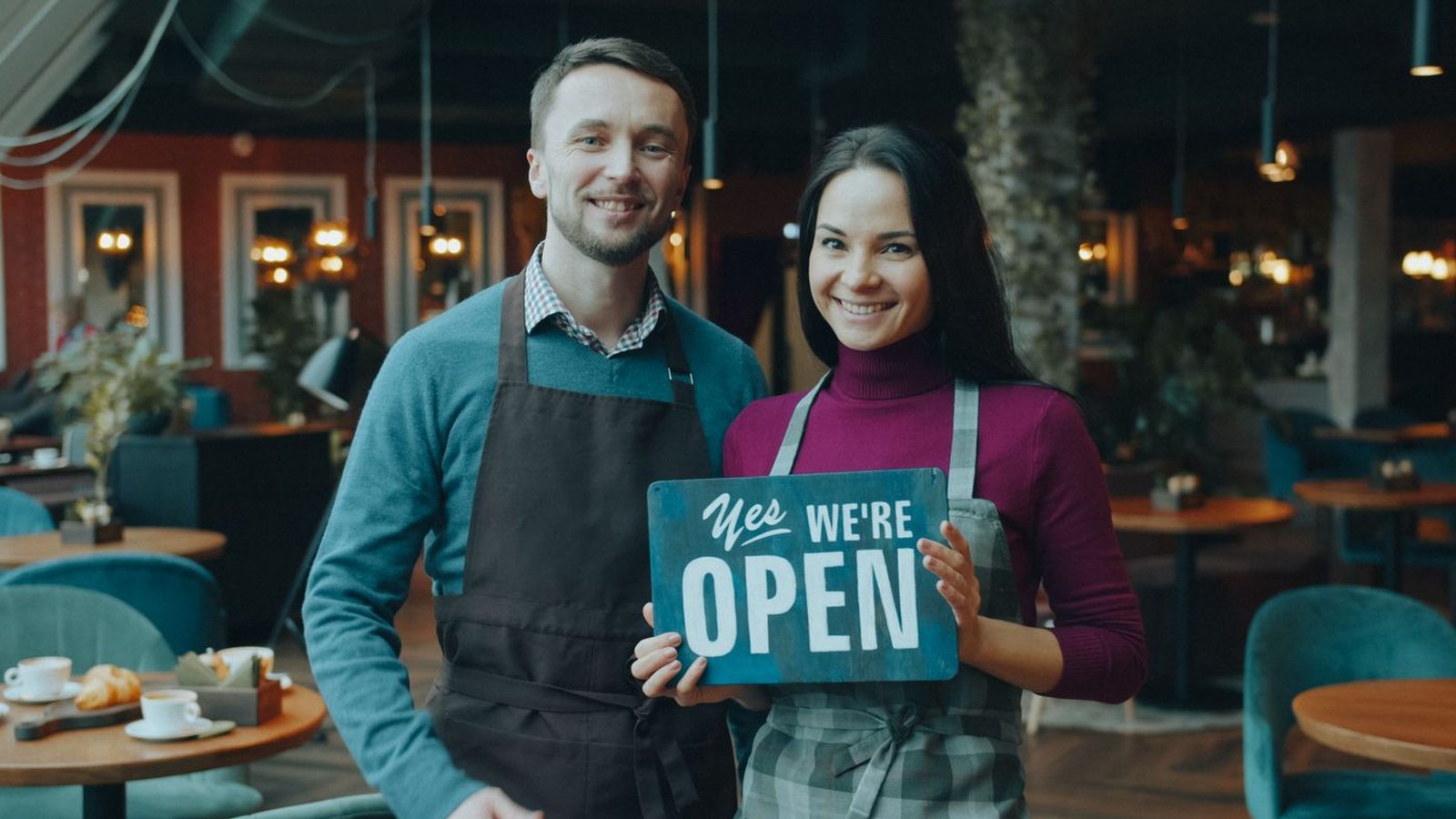 Two small business owners standing in their shop